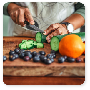 Men cutting fruits in kitchen