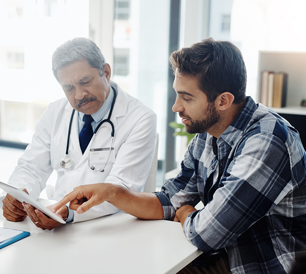 Male patient at a doctor’s appointment discussing treatment for varicocele