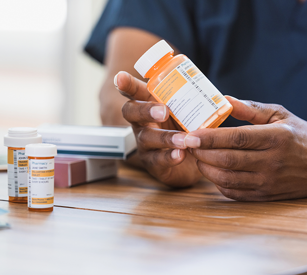 Man holding medication for scrotal pain