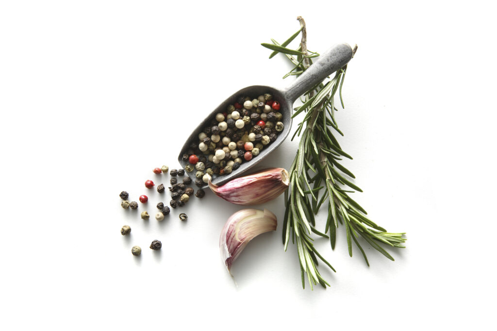 garlic, rosemary and other herbs on white background