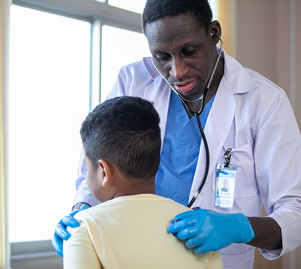 Doctor examining pediatric patient with phimosis