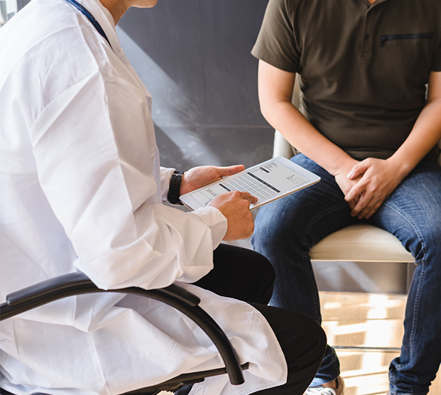 Physician speaking to patient about genitourinary reconstruction surgery