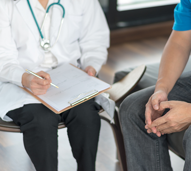 Physician speaking to patient about treatment for climacturia